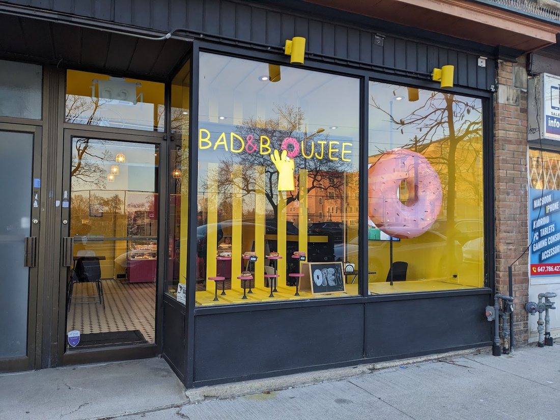 The shop door beside the window, with the open sign showing