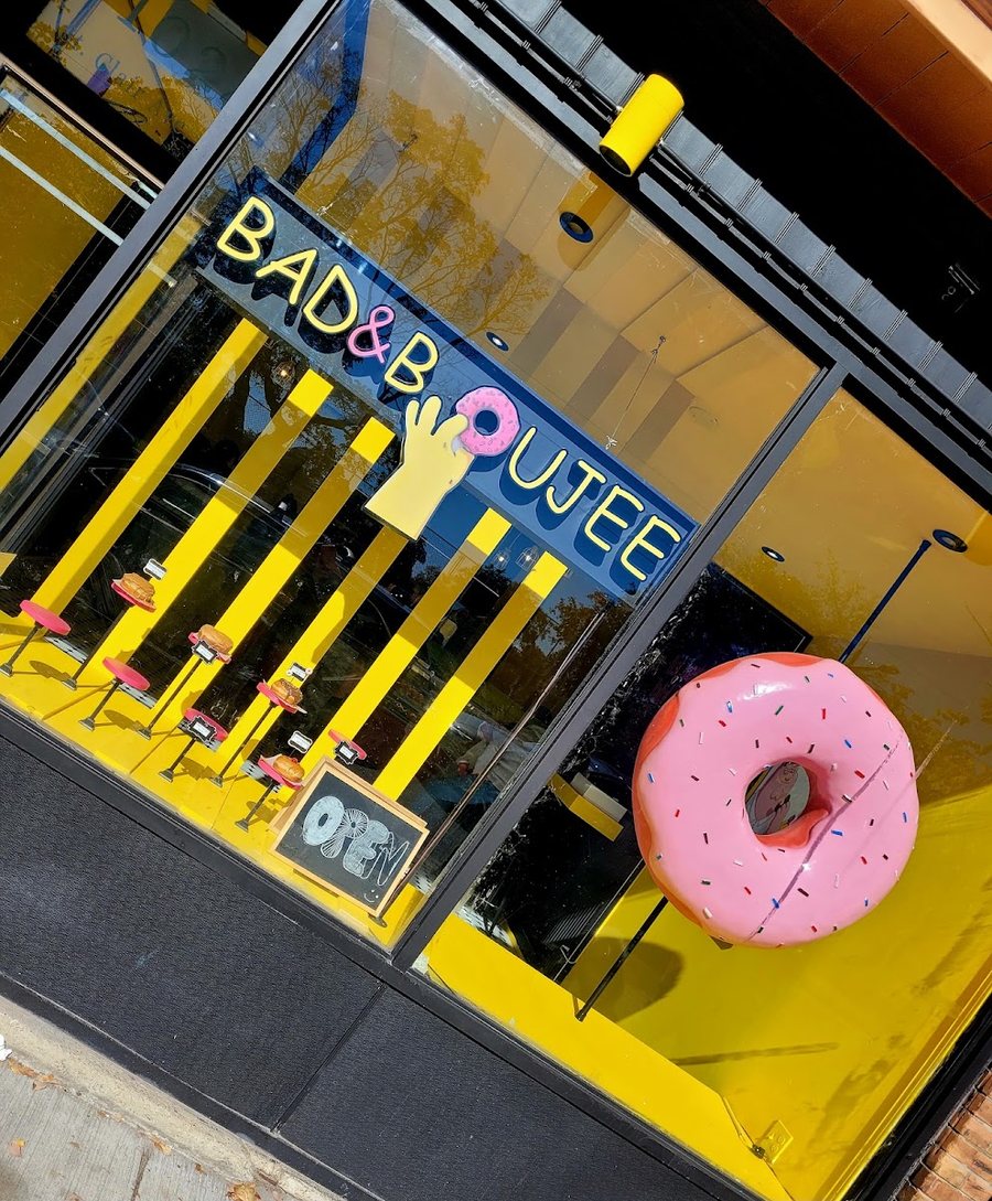 Close view of the window: the Bad and Boujee wordmark with the yellow hand, and the pink donut
